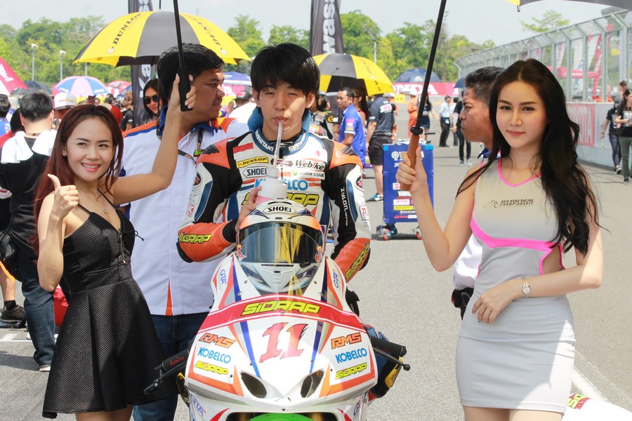 Các người mẫu che ô cho một tay đua của đội Astra Honda